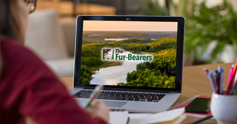 An image depicting The Fur-Bearers logo on a laptop.