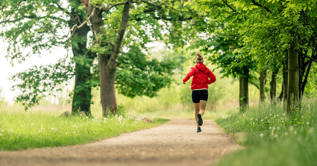 A woman running on a trail in a park