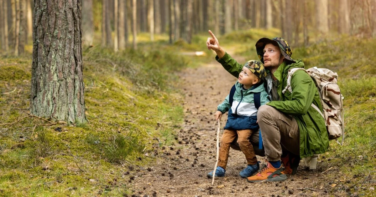 A photo of a man and child exploring in nature
